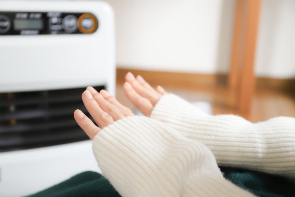 ヒーターで手を温めている様子