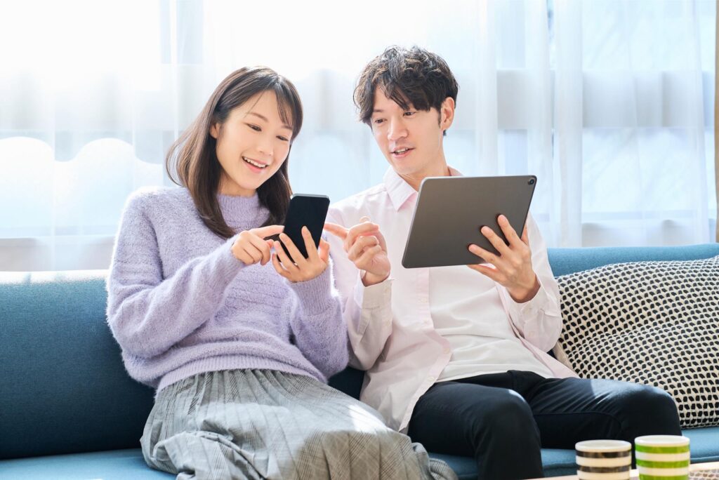 スマホで料金プランを確認する夫婦